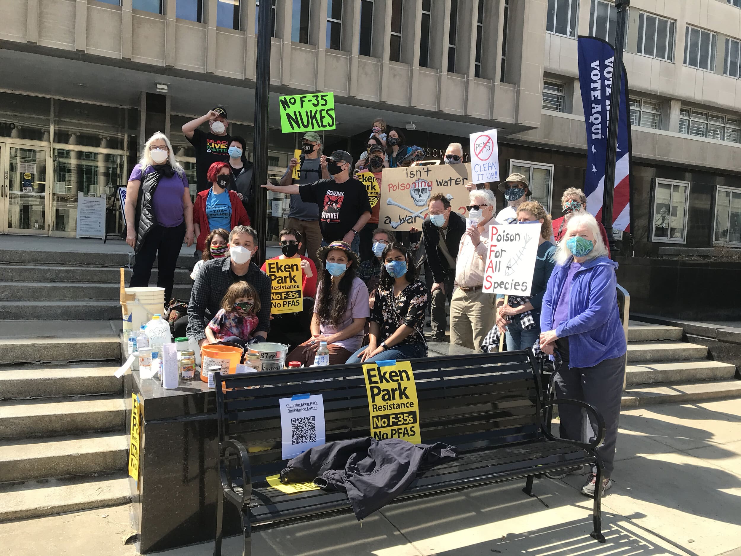 By the end of the event, 59 assorted containers of water from local lakes, rivers and taps were arranged on the steps of the City-County Building. Taped to their sides and wrapped around them were messages calling on local elected officials to addre…
