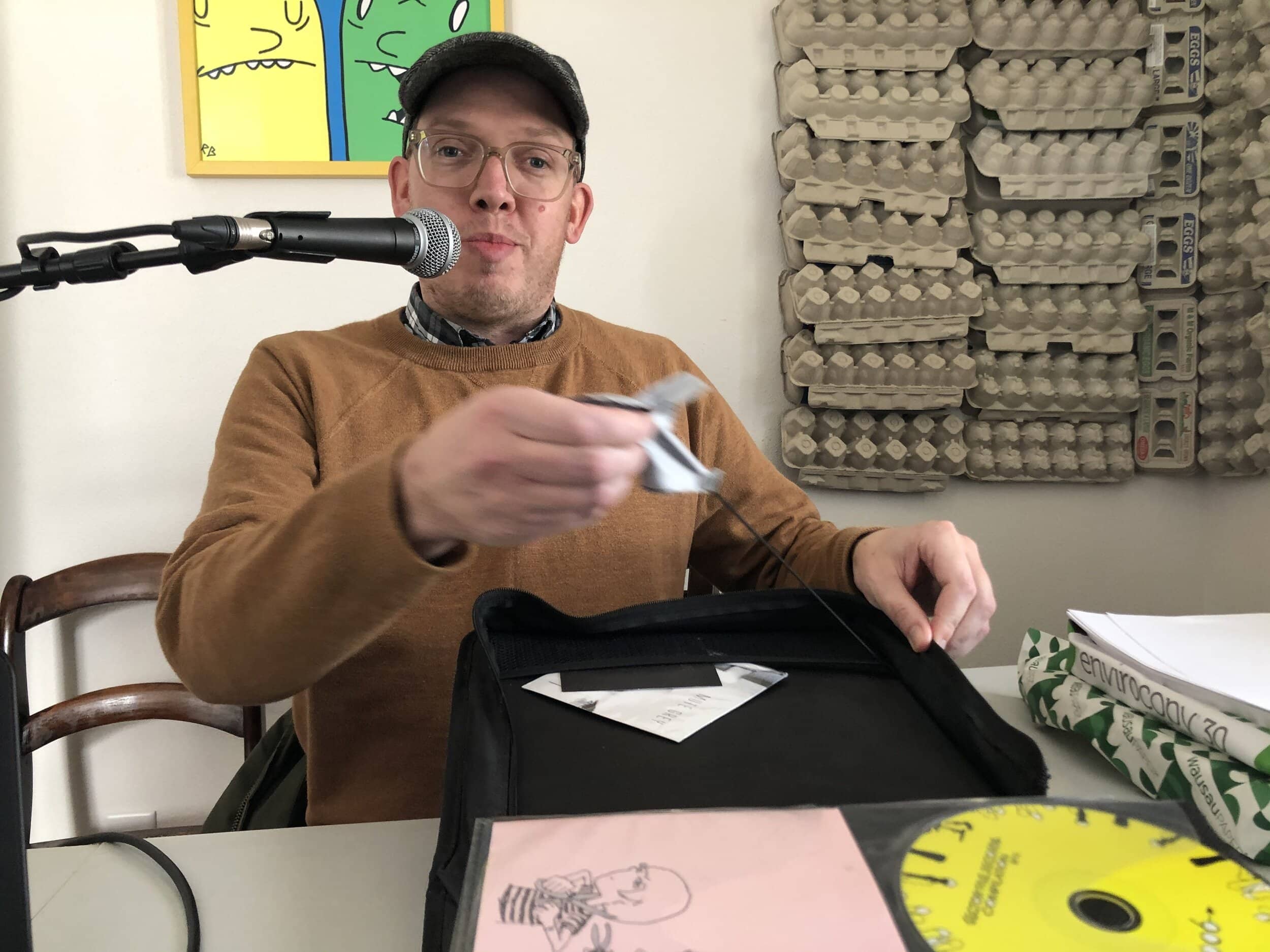 Ben Munson displays the CD book’s built-in disc cleaning cloth.