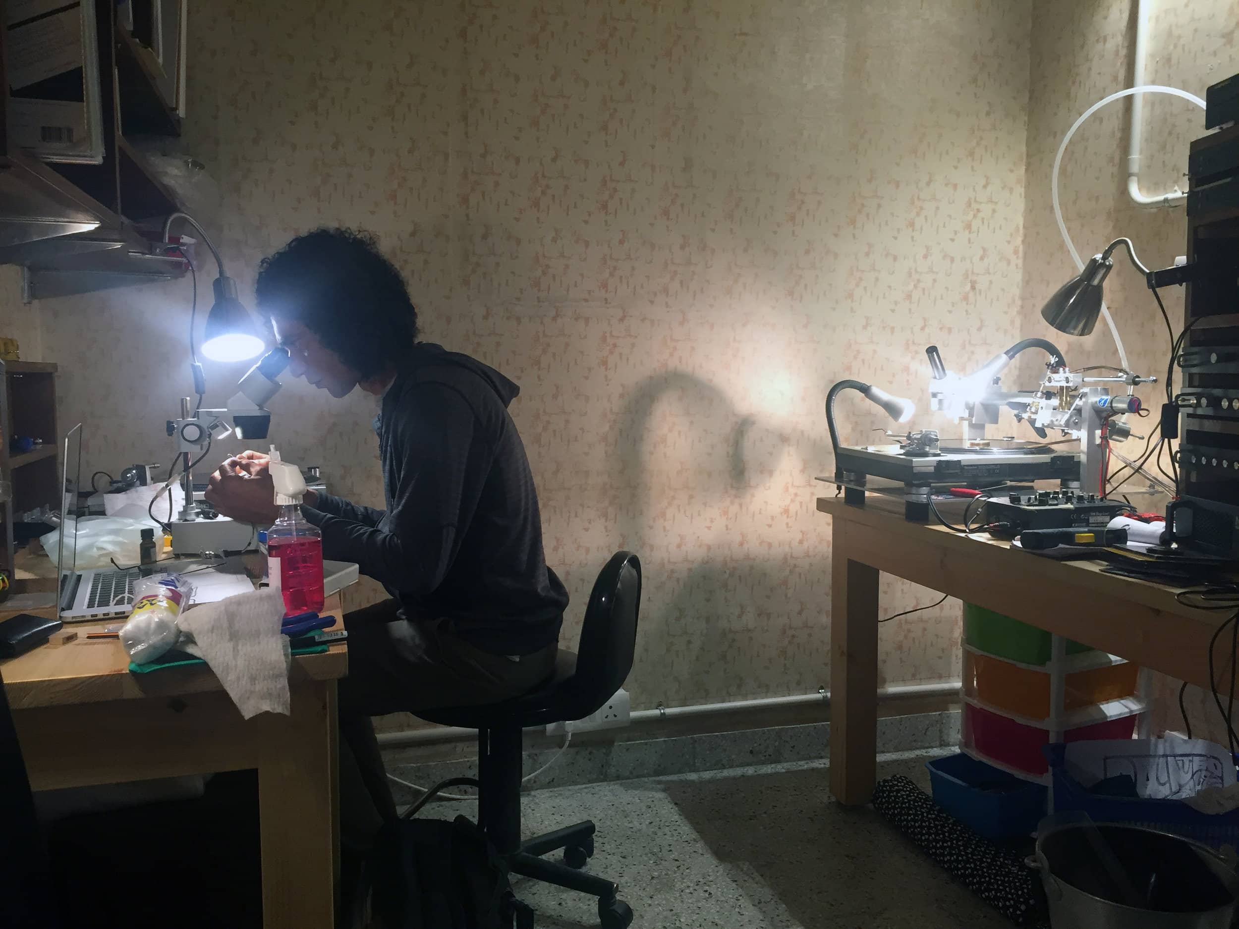 Malhotra uses a microscope to inspect a newly cut record. Photo by Ashutosh Sharma.