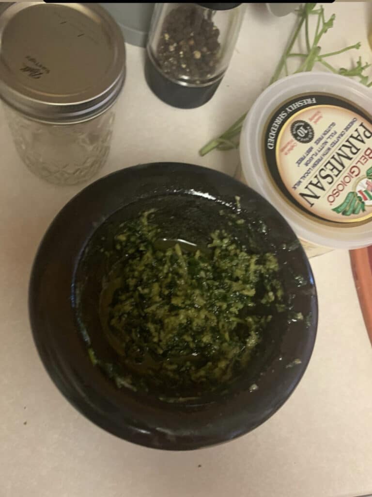 Fresh pesto in a small mortar and pestle.