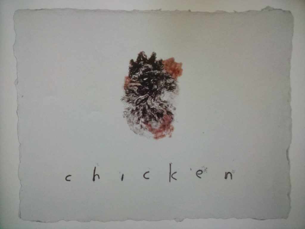 David Lynch's "Untitled (#26)," a 1999 monoprint on hand-made paper that depicts the intricately patterned deep impression of a distorted chicken face with real blood at the edges.