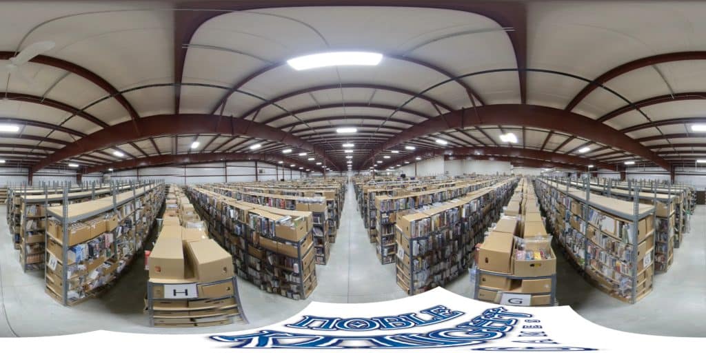 A 360-degree view of Noble Knight Games' expansive warehouse with rows and rows of shelves holding used and out of print games to be stored and shipped.