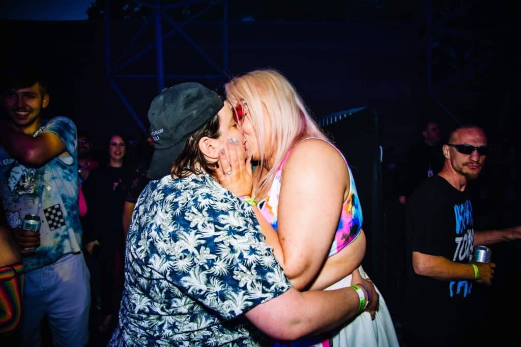 This photograph shows Olivia Steele and her partner Charli kissing on the dance floor of a club.