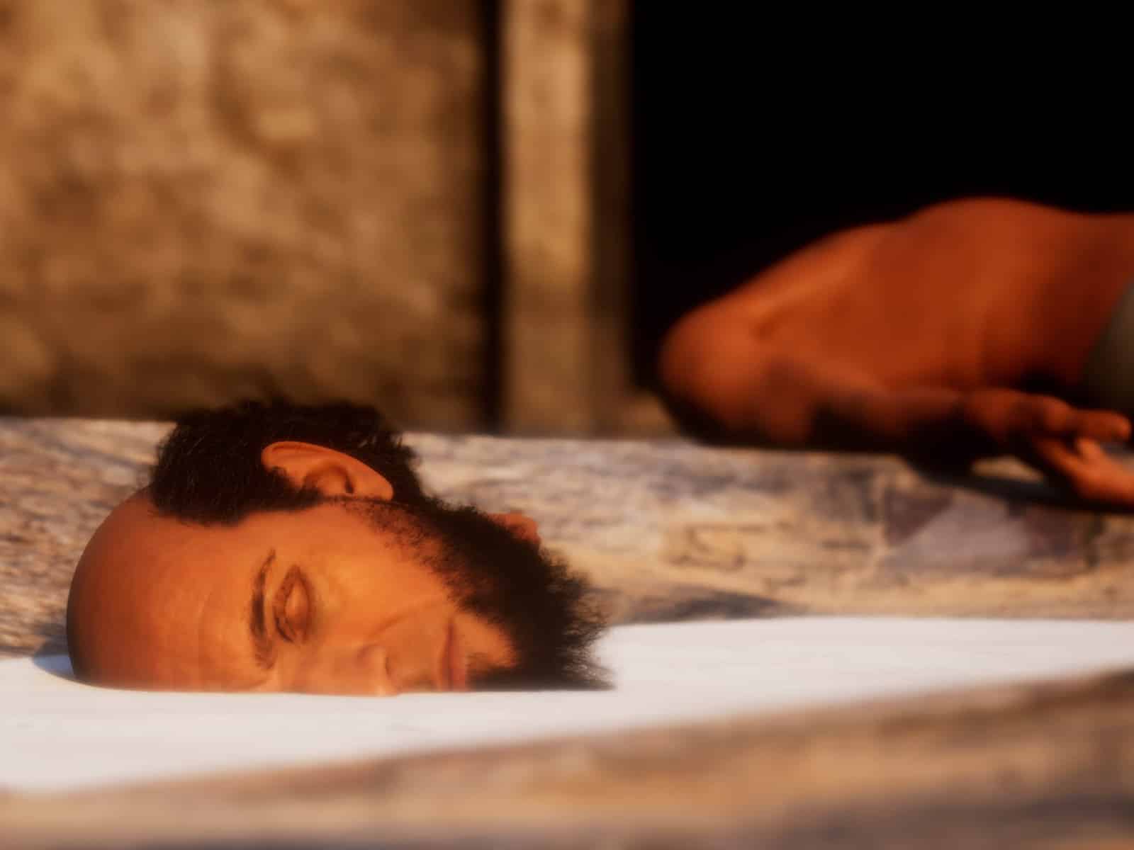 An abstract computer-generated image of a bearded, balding man's head sits on its side in a basin of white liquid.