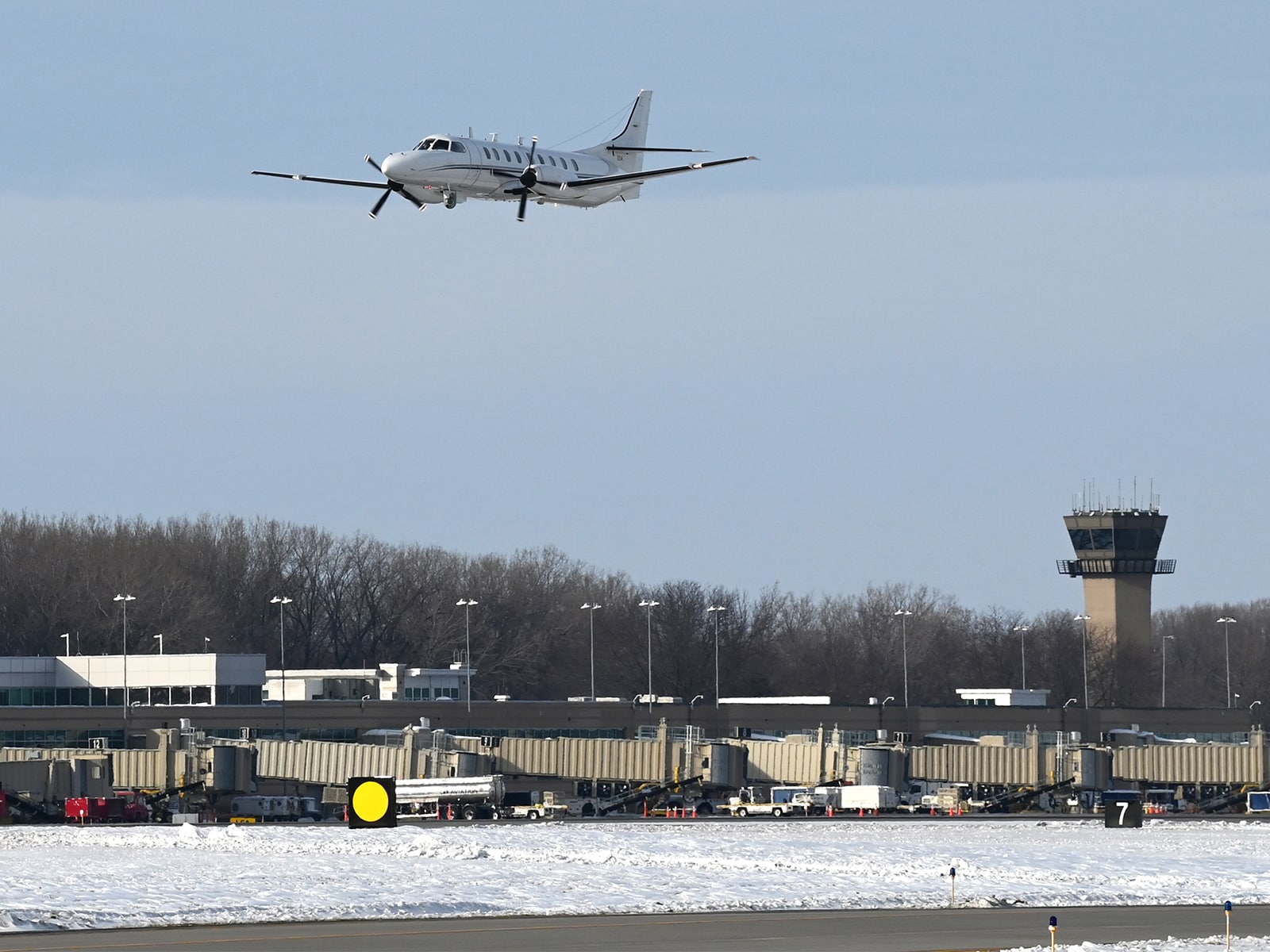 A reconnaissance plan flies low over the Dane County Airport.