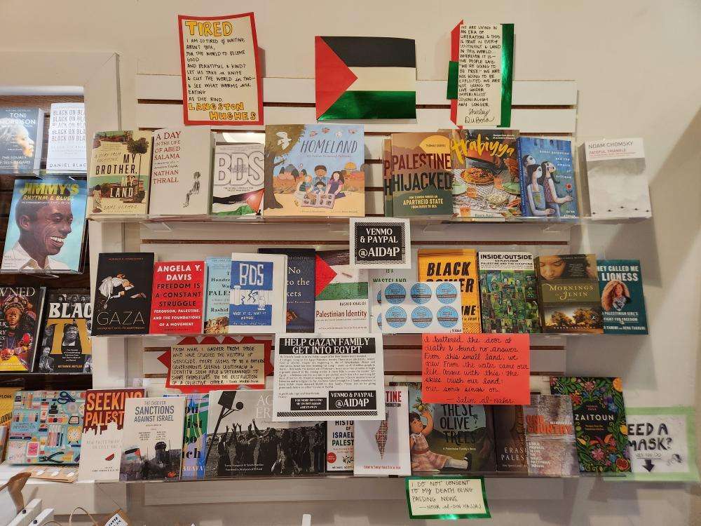 A display books and quotes on Gaza and Palestine at "Room of One's Own." 