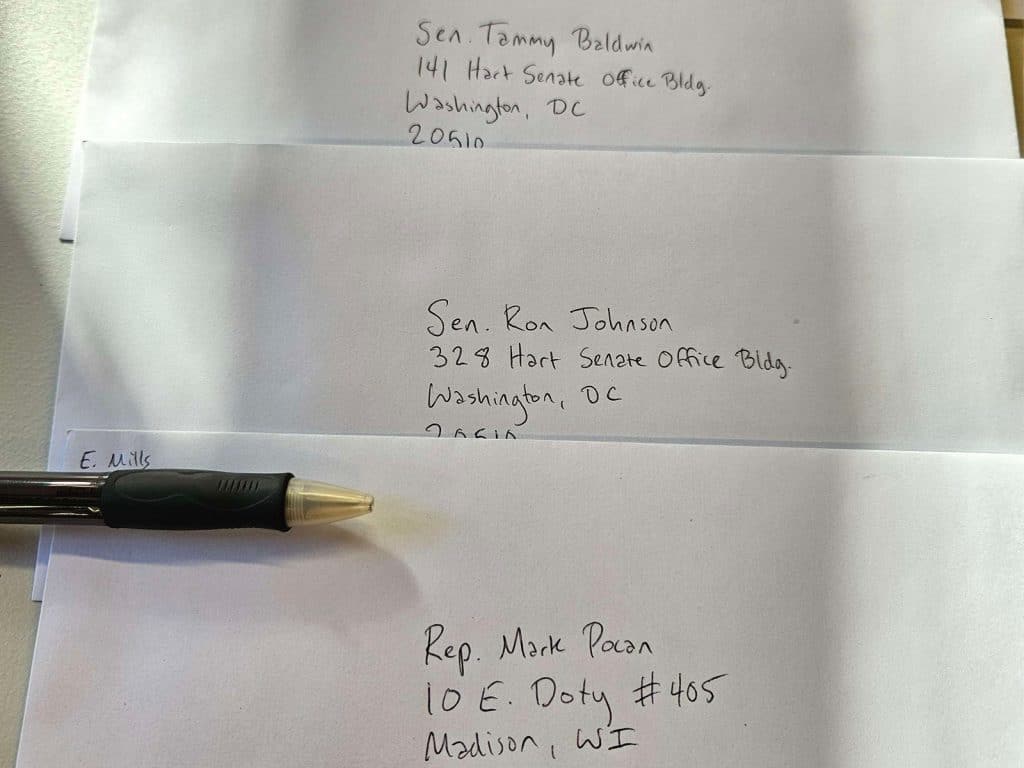 Envelopes addressed to Sen. Tammy Baldwin, Sen. Ron Johnson, and U.S. Rep. Mark Pocan. 
