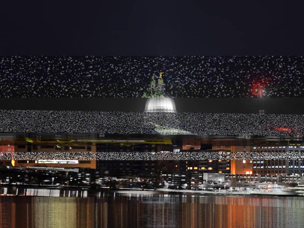 A nighttime photo of the Madison skyline is altered with horizontal strips of intermittent distortion.