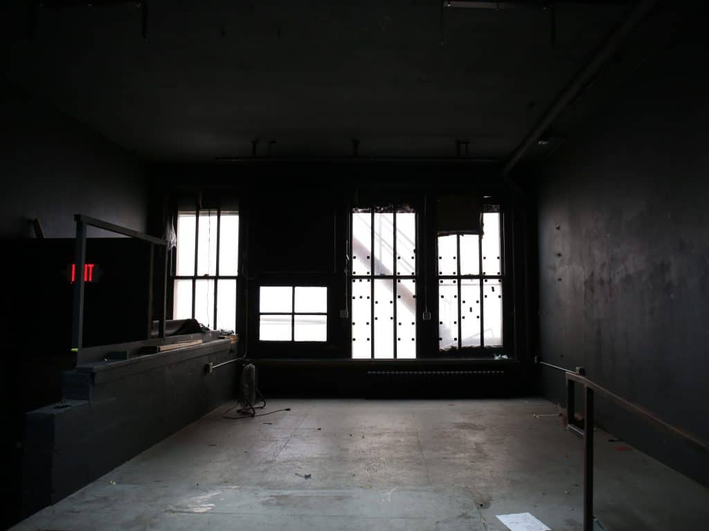 A wide empty stage is visible, with windows in the back. It's in a state of renovation in the lead-up to the opening of Gamma Ray Bar.