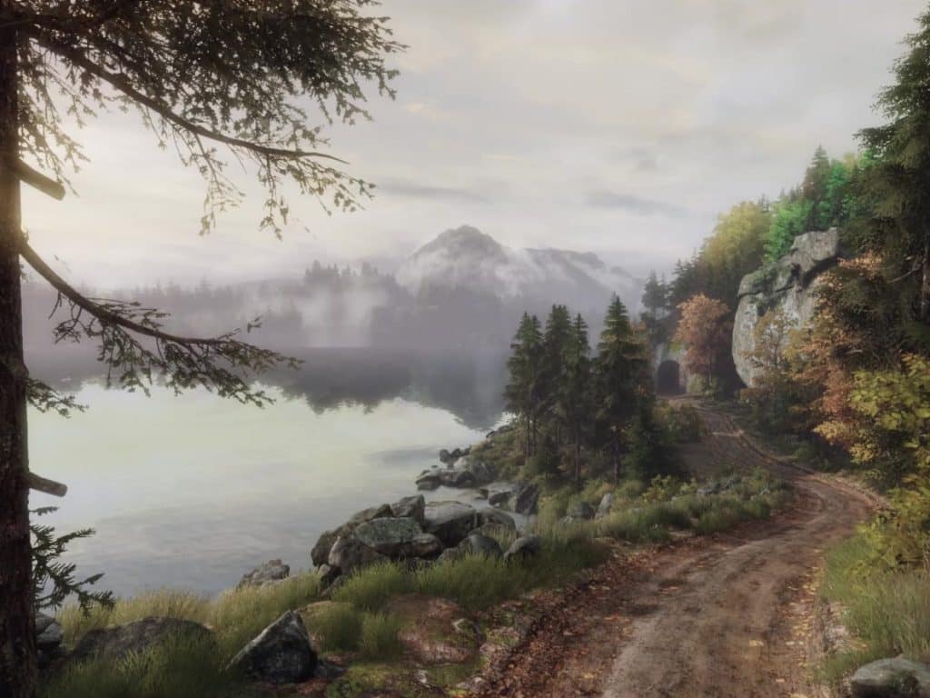 A promotional still from the video game "The Vanishing Of Ethan Carter" shows a scenic, autumnal landscape. On the left of the image is the outline of a large tree, with the sun's rays subtly peering out. A body of water is visible, and there appears to be a hilly woodland area shrouded in fog across the water. On the lower right hand corner, there is a winding dirt path that runs along the water. It's leading into a small, stone tunnel. All of it is presented in an art style that strikes a nice balance between digital art and watercolor.