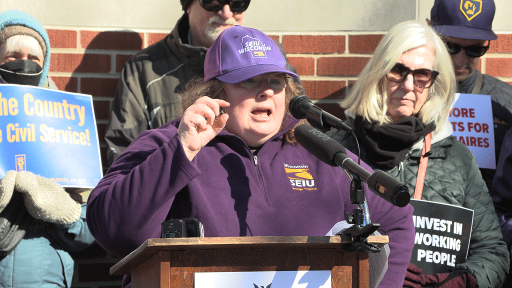 A photo shows SEIU Wisconsin president speaking at a labor rally.