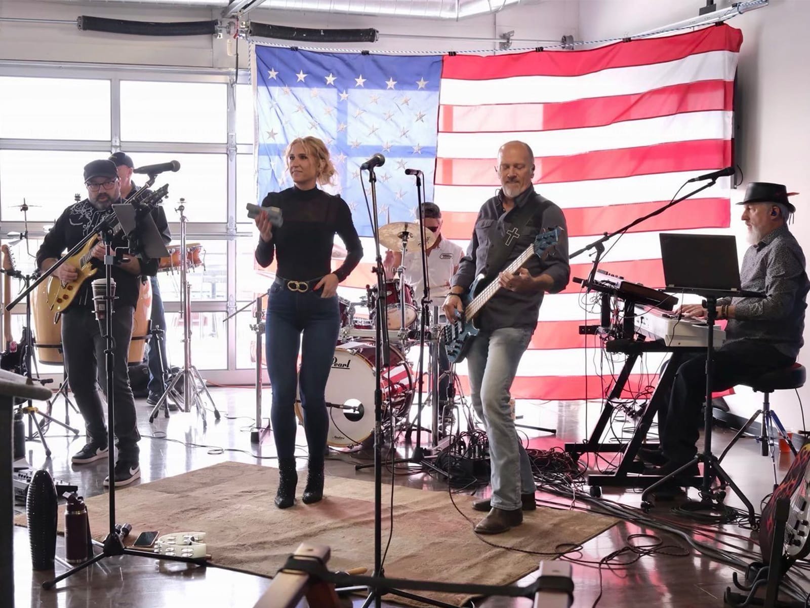 A photo shows Wisconsin Supreme Court candidate Brad Schimel playing with a rock band against an American flag backdrop.