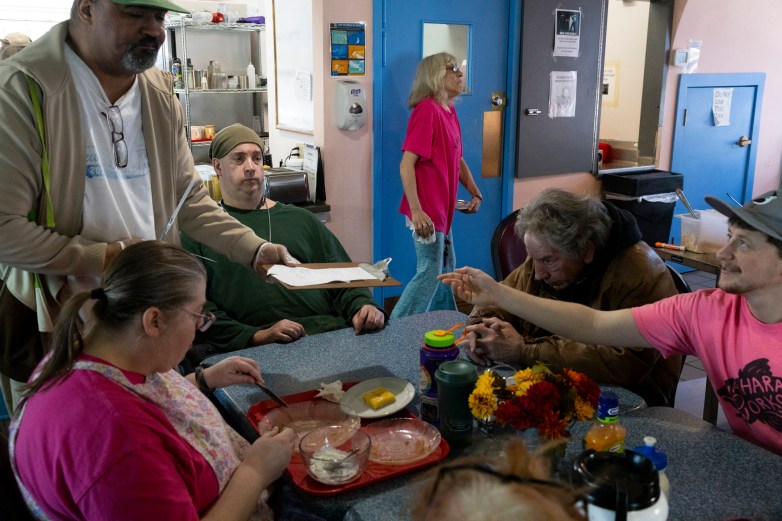 People sitting at a table and eating a meal