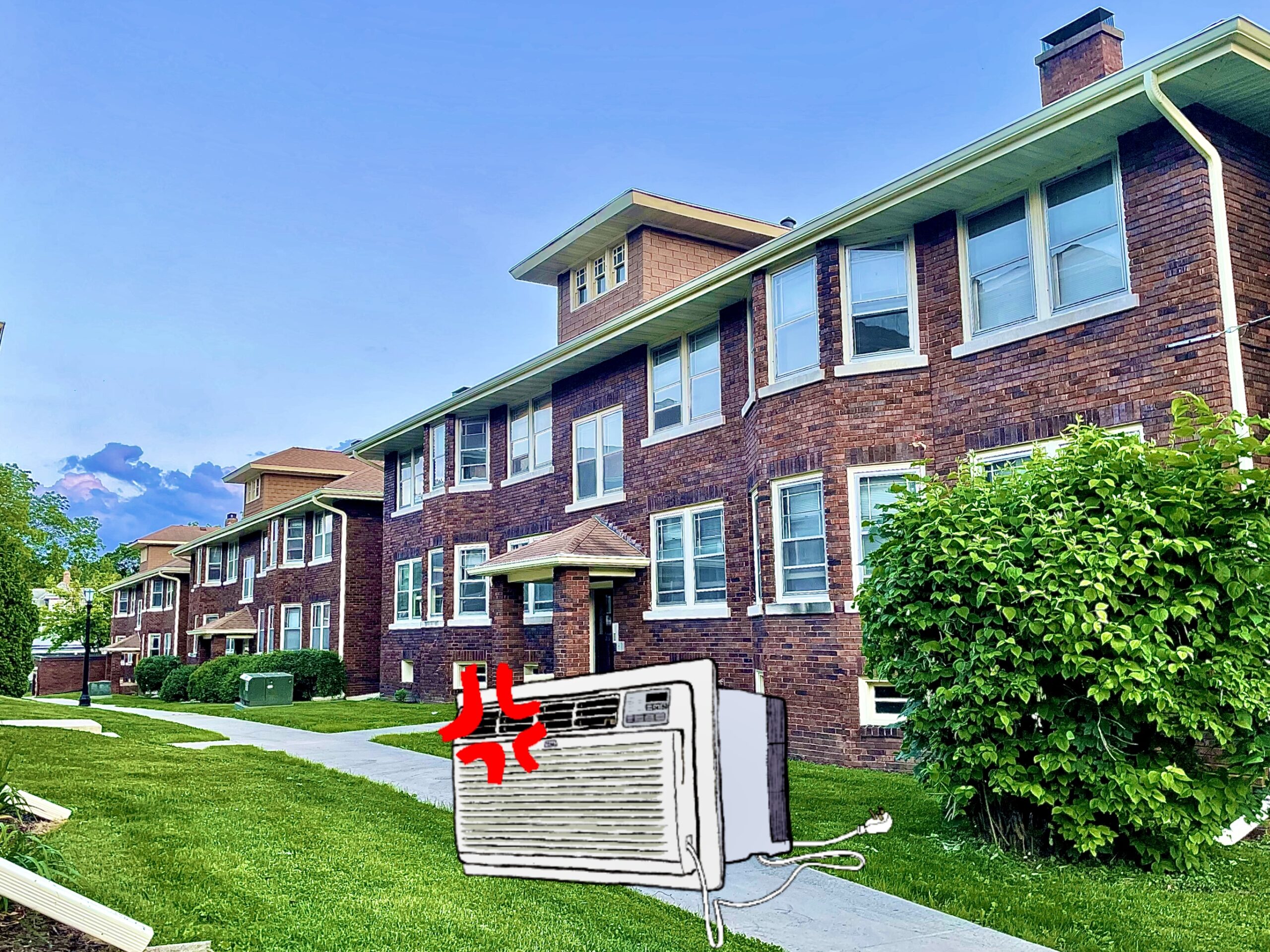 Picture of Norris Court Apartments with an angry window AC unit sitting on the lawn.|