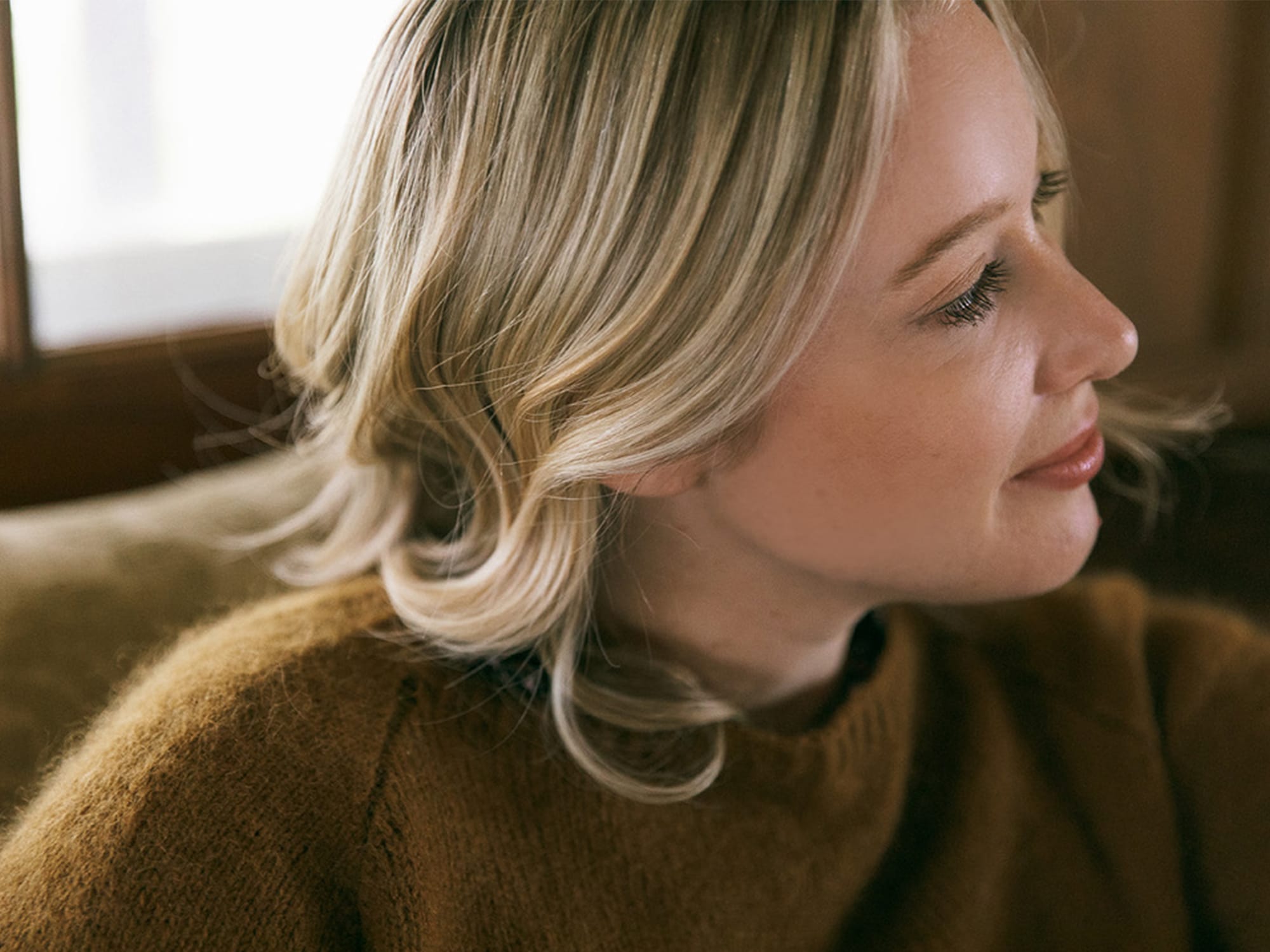 A close-up photo of Chloe Benjamin shows the author turning her head to the side in profile while seated.